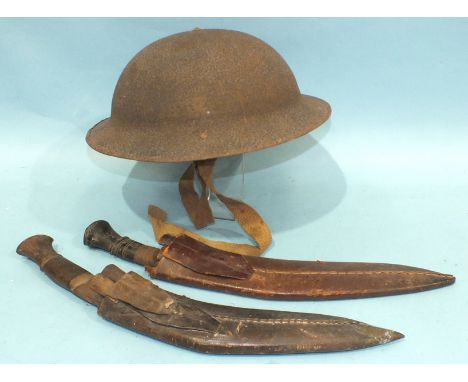 A British tin helmet, WWI, with leather liner by Hawkes &amp; Co, 1 Savile Row, London and two kukri knives, each with small 