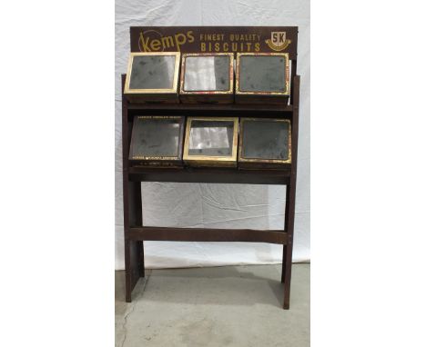 A grocer's metal shelf unit with six glass-topped display biscuit tins: Huntley &amp; Palmers (x3), Jacobs (x2) and Macfarlan