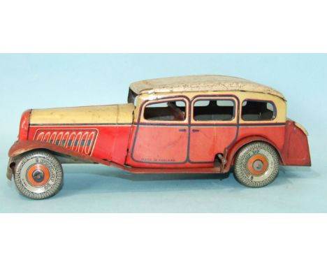 A Mettoy tinplate c/w limousine with cream and red body and 'Dunlop 90' balloon tyres, 27cm long, (surface corrosion to roof 