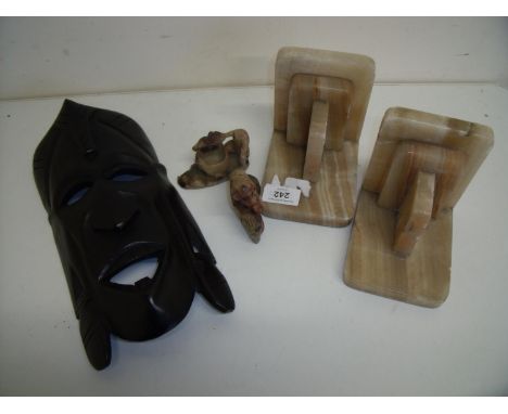 Pair of Art Deco onyx bookends, two Chinese style carved soapstone figures of monkeys, a carved hardwood African tribal mask 