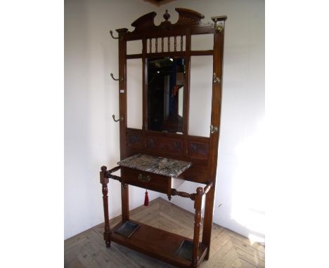 Edwardian mahogany hall stand with central bevelled edge mirrored panel above three carved panels and central drawer, on turn