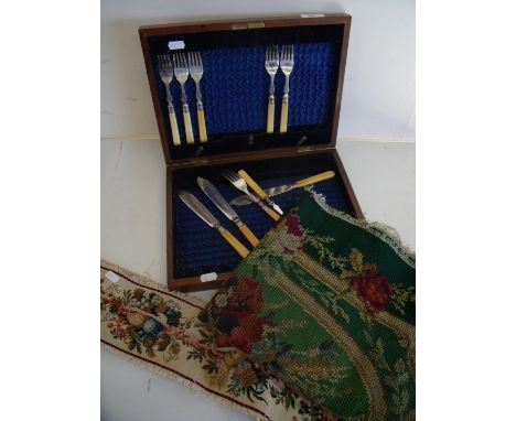 Mahogany fish knife and fork case with a small selection of contents, a Victorian wool work embroidery and a needlework panel