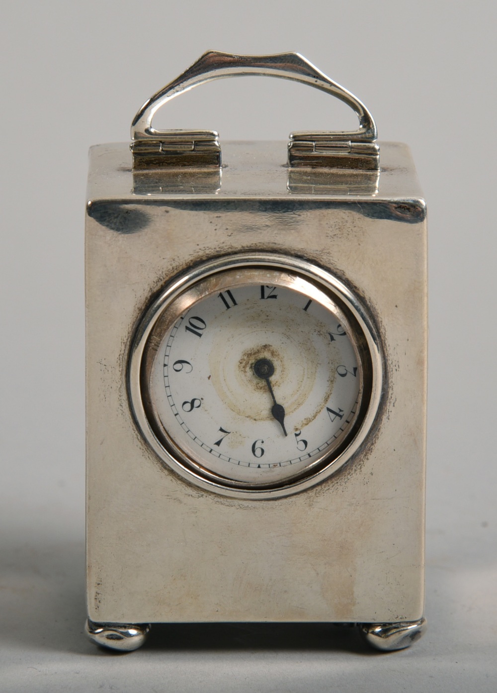 A silver bedside clock, makers mark for Liberty & Co, Birmingham 1911, a/f, 3.25in h handle raise