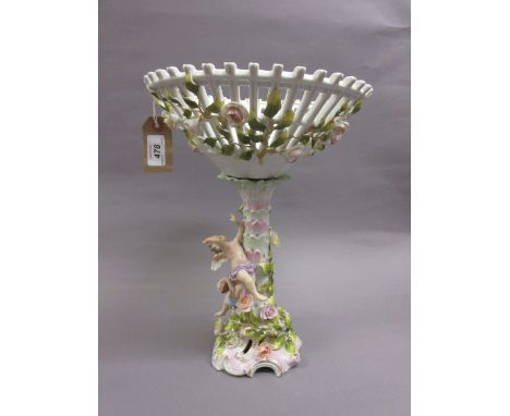 Continental porcelain floral encrusted table centre, the column with figures of winged cherubs playing musical instruments