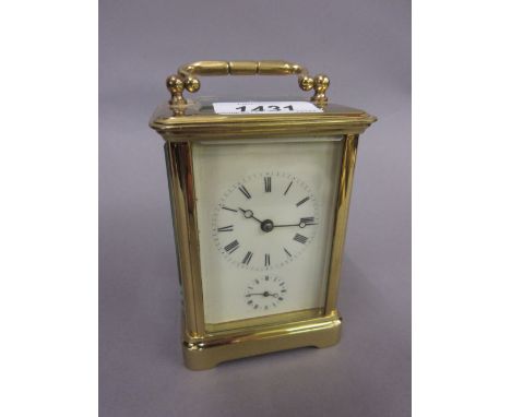 Early 20th Century brass cased carriage clock with an enamel dial, Roman numerals, subsidiary alarm dial and two train moveme