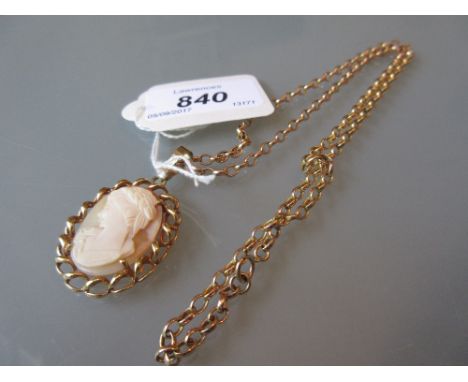 Oval carved shell cameo portrait pendant in a gilt metal mount suspended from a 9ct gold chain