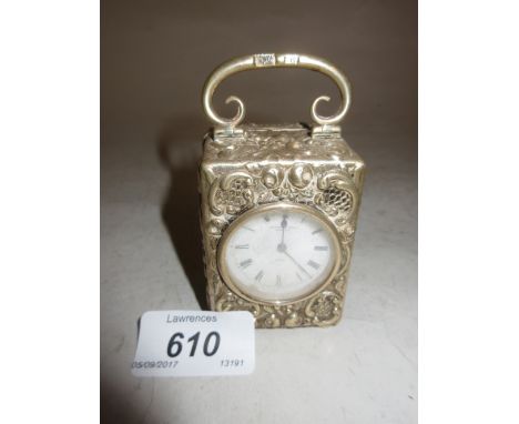 Miniature embossed London silver cased dressing table clock with enamel dial and Roman numerals, signed Mappin and Webb, Lond