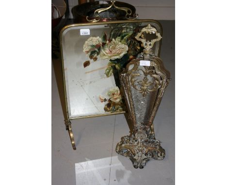 Art Nouveau brass mirrored firescreen with floral painted decoration, together with a folding brass fan sparkguard