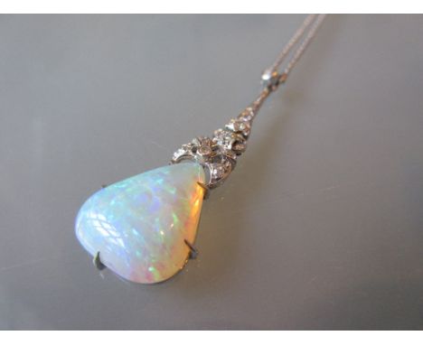 Art Deco 9ct white gold opal and diamond set pendant, the triangular form opal suspended from an articulated diamond set bow 