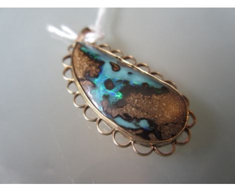 Oval gold mounted opal pendant