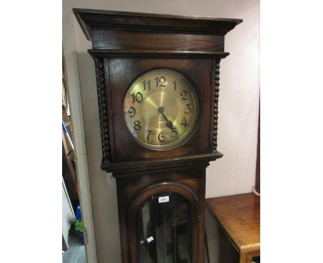 Oak longcase clock circa 1930, the circular brass dial with Arabic numerals and two train weight driven movement