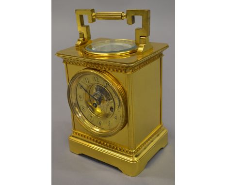 Late 19th or early 20th Century gilt brass Goliath carriage clock, the gilt dial with Arabic numerals, visible escapement and
