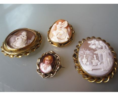 Group of three 19th Century gilt metal mounted carved shell cameo brooches of a kneeling figure, an angel and figures in a la