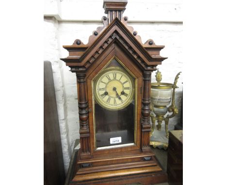 American walnut cased mantel clock having turned decoration with circular dial and two train movement striking on a gong