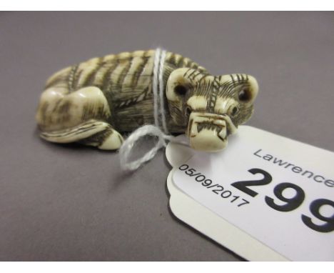 Japanese Meiji period carved ivory netsuke in the form of a reclning bullock, 5cms wide approximately