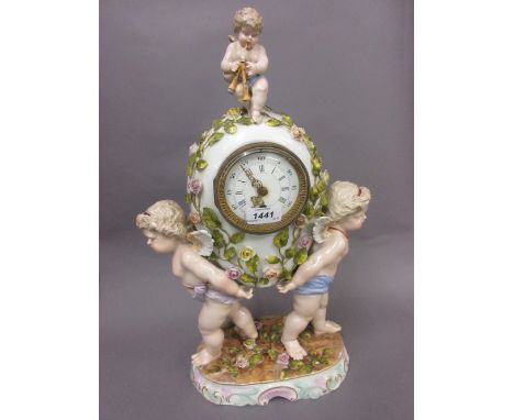 19th Century Continental porcelain floral encrusted mantel clock, supported by two figures of winged cherubs, having  circula