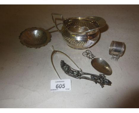 Sheffield silver cream jug, pair of sugar nips in the form of a wishbone, caddy spoon, napkin ring, tea strainer and an ornam