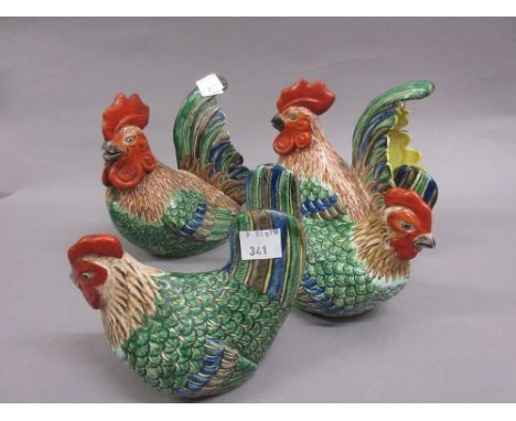 Two pairs of Chinese porcelain figures of cockerels and hens, decorated in red, green, blue etc.