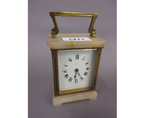 Early 20th Century brass and onyx cased carriage clock, the enamel dial with an oval chapter ring and Roman numerals, indisti