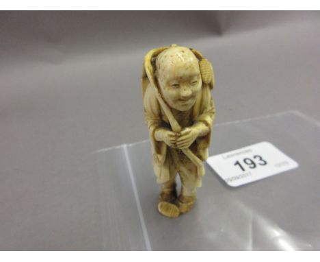 Japanese Meiji period ivory netsuke, carved as a mask seller