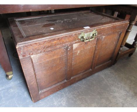 Late 19th or early 20th Century oak trunk, the hinged lid carved with the initials G.D.E.