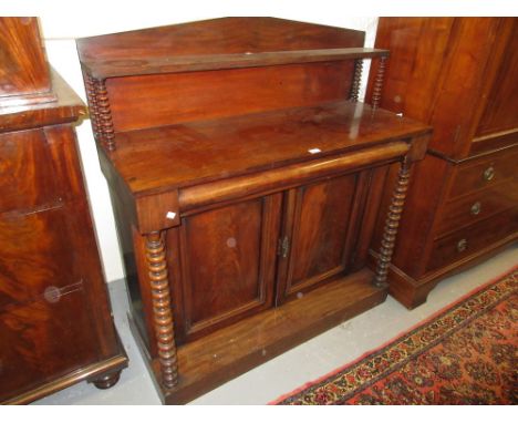 Victorian mahogany chiffonier with an arched shelf back above single drawer and two panelled doors flanked by spiral columns 