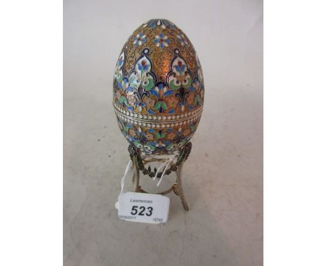 Continental silver, silver gilt and coloured enamel egg form box bearing pseudo Fabergé marks mounted on an associated stand,