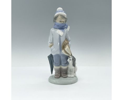 Depicts a sweet little boy bundled up in a winter coat and scarf, holding an umbrella and a blanket while a playful puppy wal