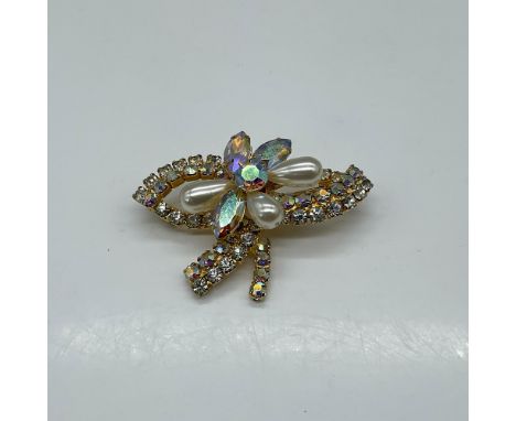 Elegant 1960's bow and flower pin featuring gold-toned metal adorned with Aurora Borealis Rhinestones, showcasing a robust go