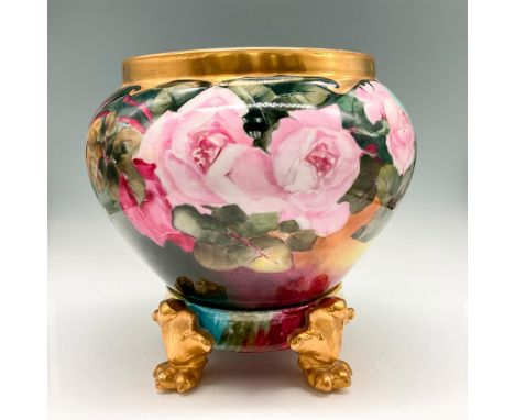Hand painted floral design over green background with gilt banded neck rim. Colored in pink, rose, green and brown. This item