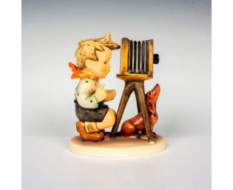 Hand painted in matte finish. A young boy takes photos with his pup by his side. Goebel backstamp. This item has its original