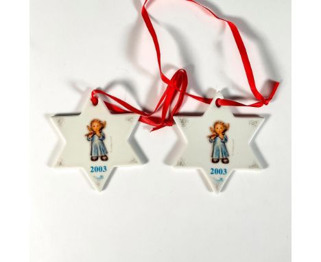 Glossy porcelain annual ornaments in the shape of stars decorated with a child angels on either side playing an instrument. G