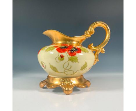 Fine poppy flower decorations set on a cream colored ground with heavy gilded touches along the border, rim, and stand. T and