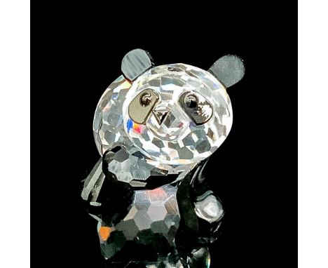 Faceted clear cut crystal panda with black-colored paws, ears, and nose. Swarovski backstamp. This item has its original box.