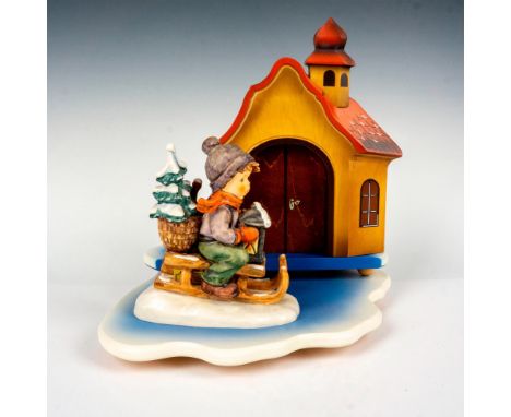 Hand painted porcelain figure of a young boy on a sleigh. Goebel backstamp. Includes a wooden display base with two parts; Wo