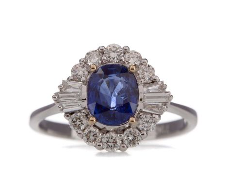 SAPPHIRE AND DIAMOND CLUSTER RING,the oval sapphire of approximately 1.39 carats, within a halo of tapered baguette and round