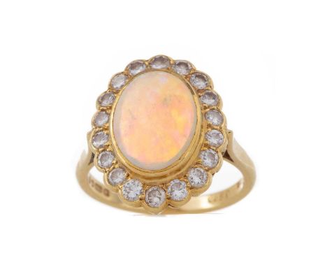 OPAL AND DIAMOND CLUSTER RING,set with a cabochon opal 12mm long, within a halo of round brilliant cut diamonds totalling app