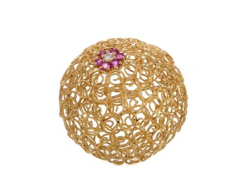 RUBY AND DIAMOND BROOCH,of openwork convex design, with central ruby and diamond flower cluster, 37mm in diameter, marked 18K