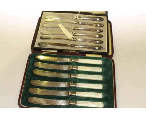 Set of six silver and mother or pearl handled butter knives, Sheffield 1914 by Walker & Hall and six silver handled butter kn