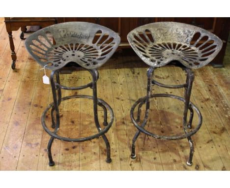 Pair vintage iron tractor seats on later swivel bases