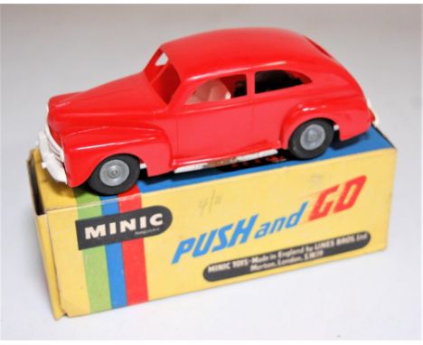 Triang Minic Post War Ford Tudor Saloon, red plastic body with white grille, friction drive motor, cast hubs, in the original