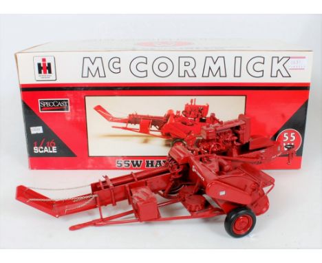 Speccast 1/16th scale resin scale model of a McCormick 55W Hay Baler, finished in red, with black tyres, in the original poly