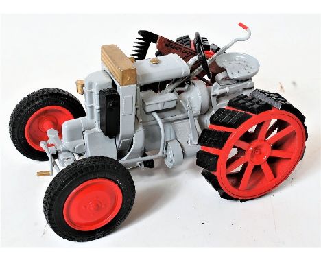 A 1/32nd scale white metal and resin model of a Hurlimann 1 K 10 1930 tractor, finished in grey with red and black wheels, wi