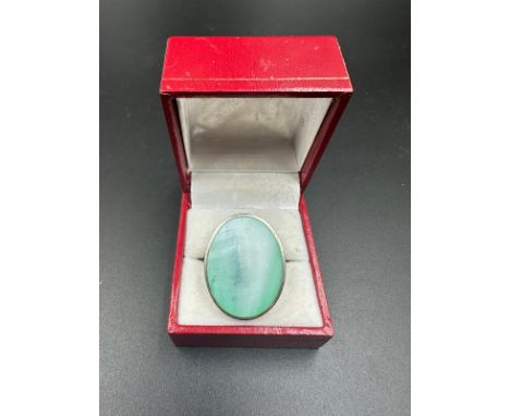 A silver and jade ring, approximate size Q.