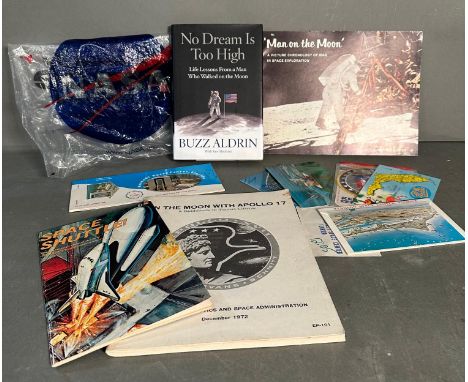A selection of Nasa memorabilia to include postcards and a ticket from the Kennedy Space centre and other pamphlets and books