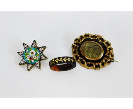 A 19th century black enamel and hair locket mourning brooch together with a micro mosaic brooch and a tortoiseshell and yello