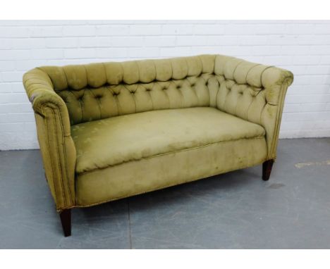 A button back Chesterfield sofa of small  proportions, upholstered in pale green fleur de lys fabric, on tapering supports, 1