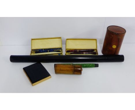 A mixed lot to include a leather mounted Stratton compact, a set of gilt metal cups in a leather case, a fountain pen, two bo