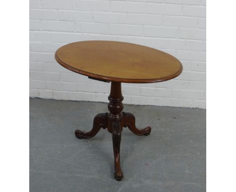 A mahogany wine table, the oval top on carved tripod supports  58 x 66cm