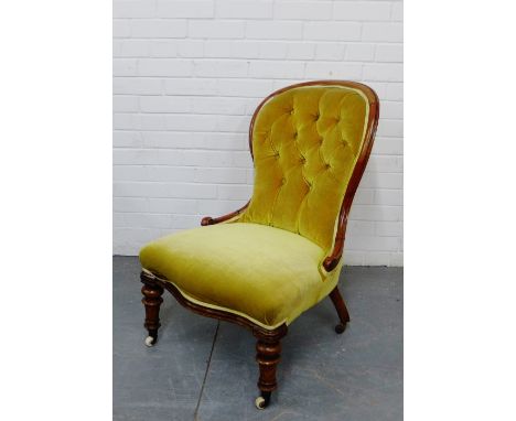 A mahogany framed button back chair on turned supports and ceramic castors, 86 x 60cm